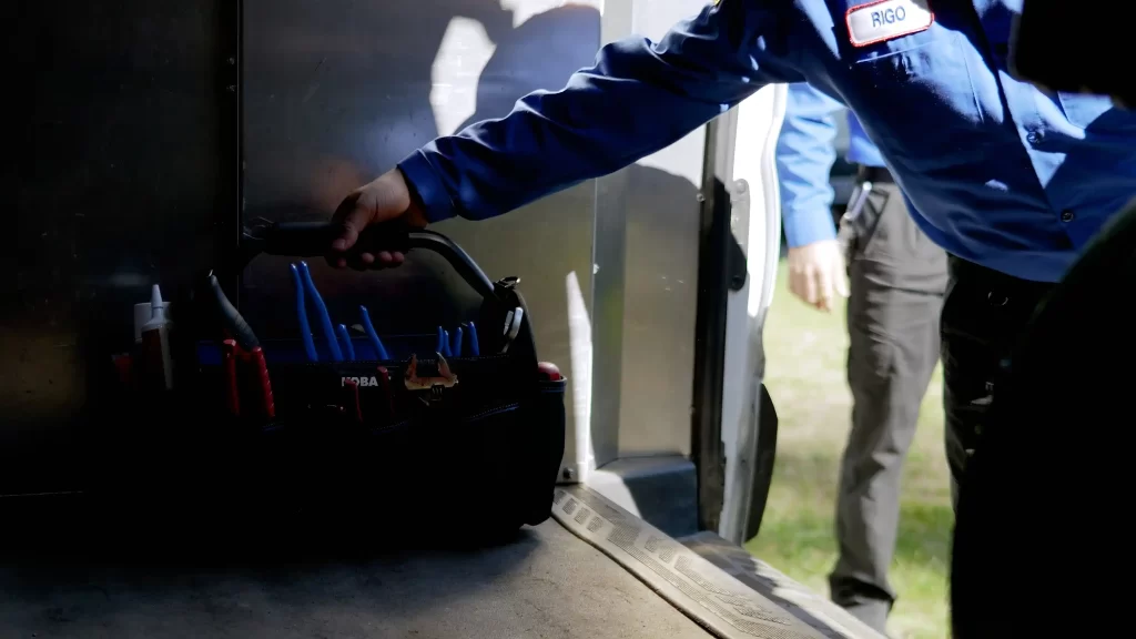 a man holding a tool bag